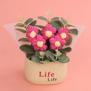 Decorative hand-knitted puff flower potted plant with eucalyptus leaves in a cream Life pot