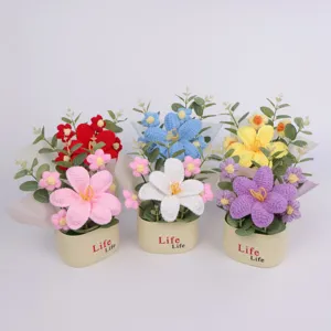 Close-up of hand-knitted crochet flower potted plant with vibrant yarn texture