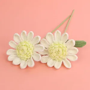 High-quality close-up of handmade crochet white daisy flowers showing detailed yarn texture