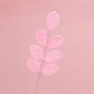 Dettaglio di un ramo di foglie di lana rosa fatto a mano per eleganti composizioni.