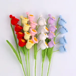 Detailed view of colorful handmade knitted lily of the valley flowers for DIY gifts