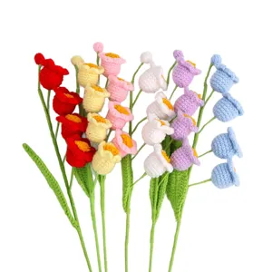 Hand-knitted colorful crochet lily of the valley bouquet for gift, white background.