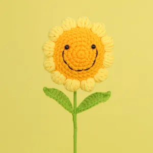 Detailed macro view of a handmade yellow crochet sunflower with a cute stitched smiley face
