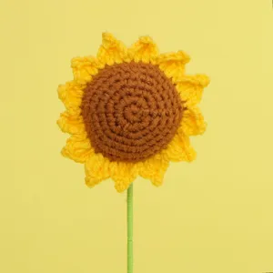 Close-up of a handmade crochet sunflower with detailed yellow petals and brown center