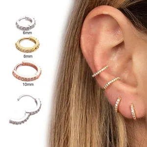 Detailed view of 6mm, 8mm, 10mm CZ hoop earrings showing different sizes on ear.