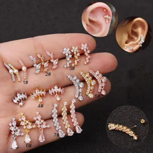 Detailed view of stainless steel cartilage studs with sparkling zircon and wing designs