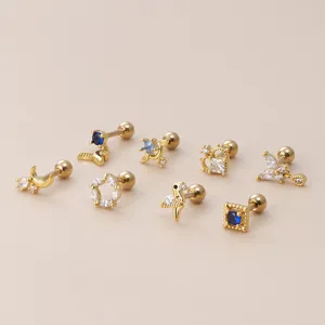Gold cartilage stud earrings set with sparkling zircon shapes for ear piercing.