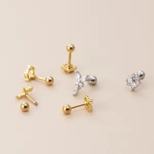 Set of zircon cartilage earrings with butterfly and heart studs in gold and silver finishes.