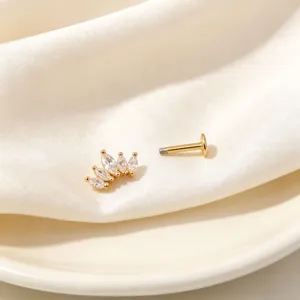 Close-up detail of a gold crown piercing stud with marquise cubic zirconia stones.