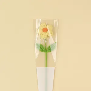 Detailed view of a handmade crochet puff flower inside romantic "LOVE" gift packaging