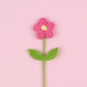 Detailed view of a handmade pink crochet puff flower with intricate knit texture.