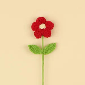 Close-up detail of a handmade red crochet puff flower showing texture and craftsmanship