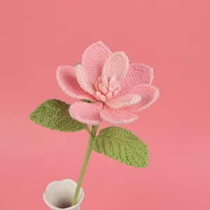 Detailed macro view of a handmade crochet pink magnolia flower with delicate textures