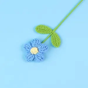 Detailed view of a hand-crocheted blue puff flower with green stem for home decoration