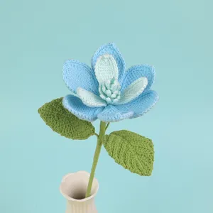 Close-up of hand-crocheted blue magnolia flower with detailed yarn texture