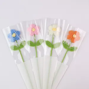Detailed view of handmade crochet puff flowers in assorted colors with gift packaging