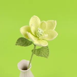 Hand-crochet magnolia flower with detailed yarn texture in a white vase