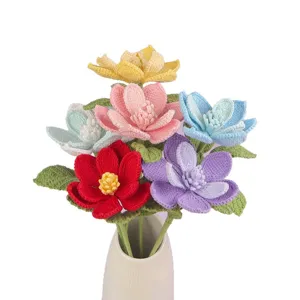 Hand-crocheted colorful magnolia flower bouquet in a minimalist white vase.