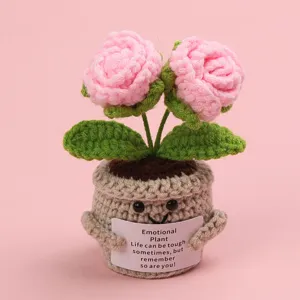 Close-up of handmade crochet rose potted plant with emotional support message card