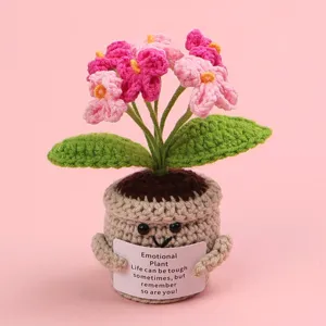 Hand-crocheted emotional potted plant with encouraging message on pink background