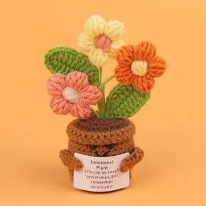 Detailed view of a handmade knitted emotional plant with an encouraging message card