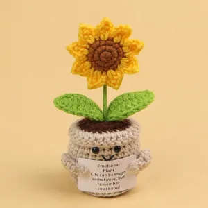 Detail of crocheted sunflower emotional plant with motivational message card.
