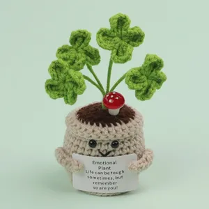 Close-up of a handmade crochet emotional plant with a motivational message card.