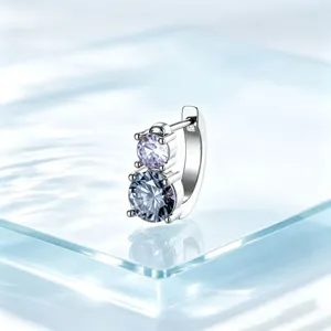 Detailed close-up of a titanium steel huggie earring with stacked lavender and blue crystals