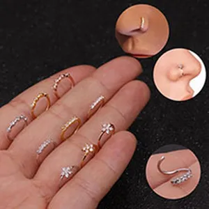 Multiple sparkling stainless steel nose rings with cubic zirconia flower and row designs.