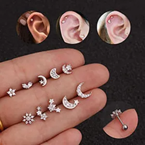 Detail view of various stainless steel ear studs with CZ star and moon designs.