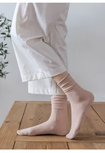 Detail view of women spring summer ultra thin breathable mesh mid tube socks with rolled cuffs.
