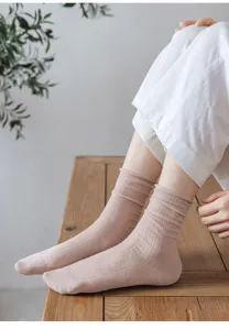 Detail view of ultra-thin breathable mesh womens mid-tube socks with cute rolled cuffs.