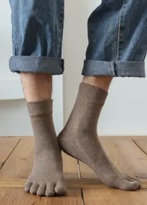 Detail shot of brown wool toe socks, five-toe split design, cozy and warm for winter.