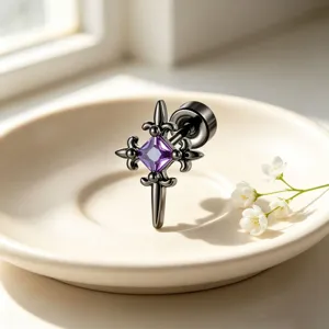 Close-up macro view of a vintage gothic punk cross stud earring with purple zircon
