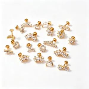 Assortment of gold stainless steel cartilage studs with crystal crown and moon designs.