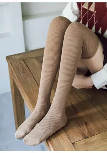 Close-up detail shot of khaki ribbed over-the-knee high socks showcasing texture and fit.