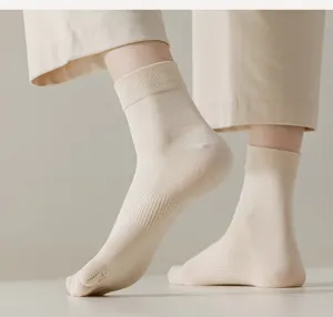 Close-up detail of women's beige five-toe socks, soft combed cotton, comfortable fit.