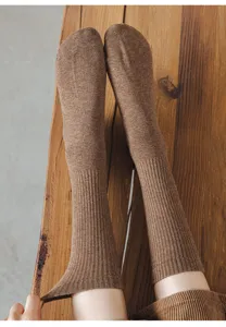 Detailed closeup of brown long ribbed cotton socks, cozy winter hosiery for women.