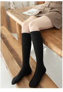 Detailed view of plus size black knee high long socks, perfect for cozy winter wear.