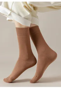 Close-up detail of thick cotton mid-calf socks for women, solid color winter wear, soft texture.