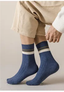 Close-up view of men's ribbed crew socks in blue with white and olive green stripes detail.
