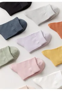 Close-up of colorful cotton mesh mid-calf socks detail showing breathable texture and neat stitching.