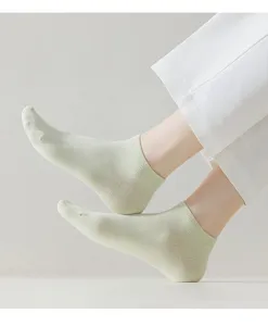 Close-up shot of avocado green cotton ankle socks, soft breathable fabric, lifestyle detail view.