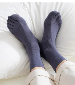 Grey mesh breathable five-toe mid-tube socks detail view, comfortable anti-odor athletic wear.