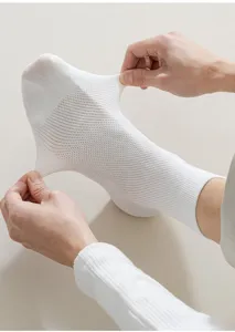 Detailed view of white mesh breathable men socks with high elasticity and stretch feature.