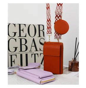 Detail of orange and lilac crossbody phone bags with wide geometric straps and pouches