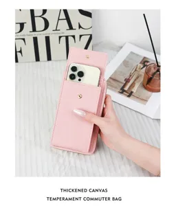 Pink pebble texture mobile phone crossbody bag and wallet held in hand showing phone slot