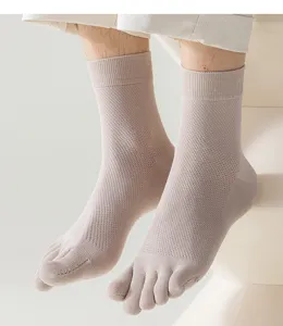 Detailed close-up view of breathable mesh five-toe mid-tube socks in solid beige color.
