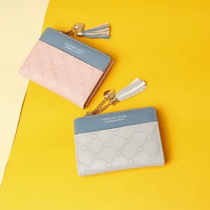 Detail view of stylish color-block women's short wallet with decorative tassel and heart