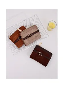 Detailed view of three minimalist short PU leather patchwork wallets with gold buckle decoration